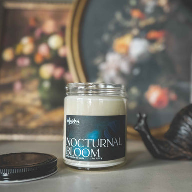 Candle jar labeled 'Nocturnal Bloom' with a decorative background