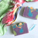 Colorful soap bars with a tie-dye fabric in the background