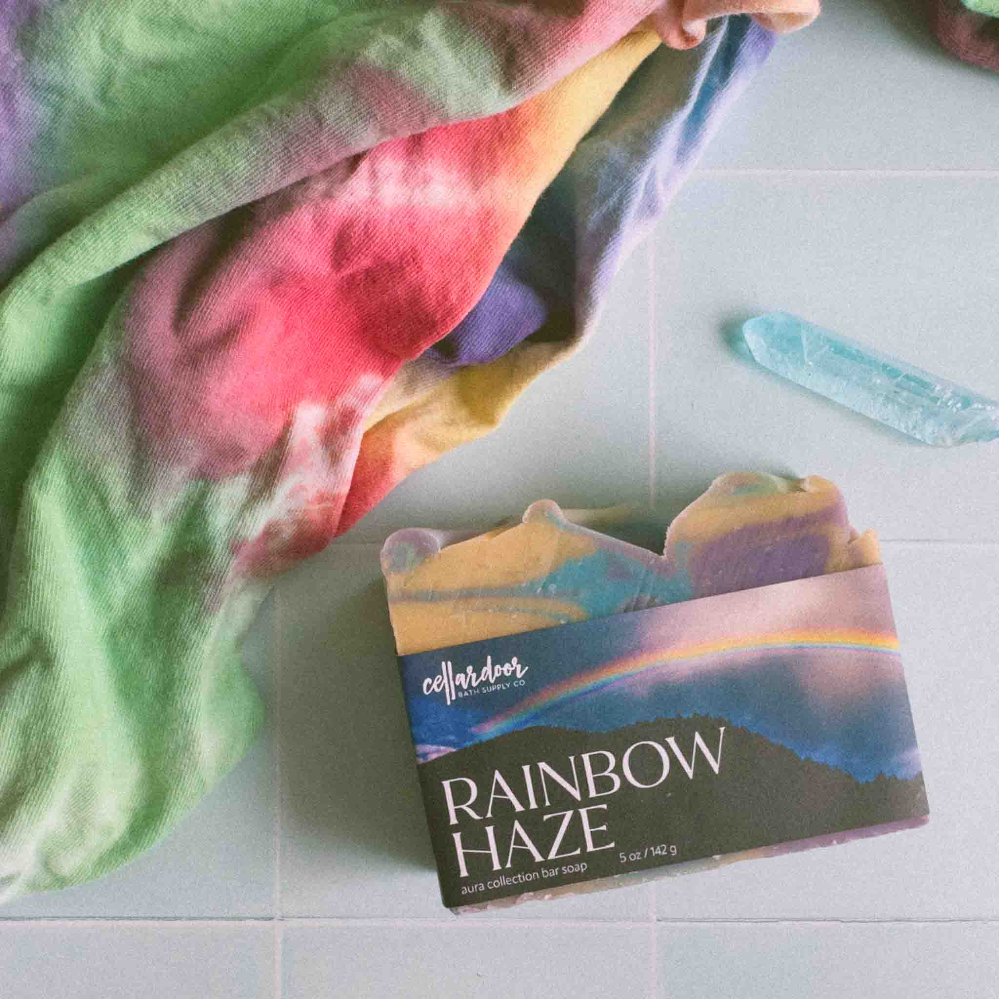 Rainbow Haze soap with a colorful towel in the background