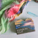 Rainbow Haze soap with a colorful towel in the background